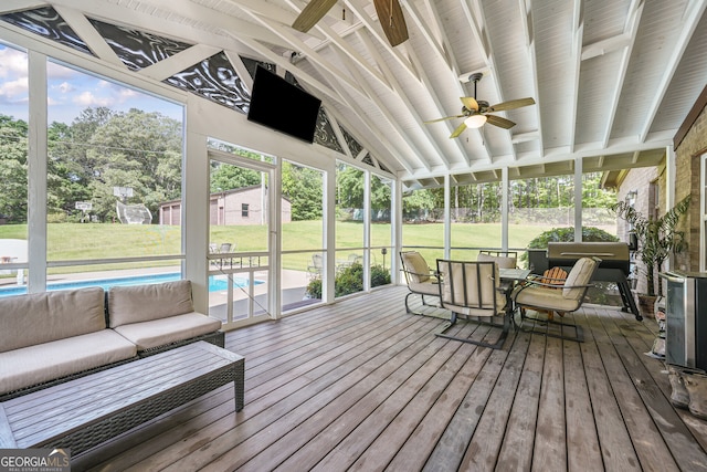 sunroom with ceiling fan, outdoor lounge area, and outdoor dining space