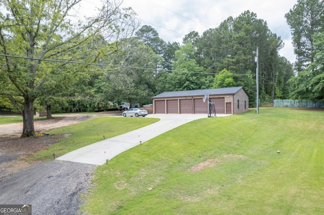 view of yard featuring a garage and driveway