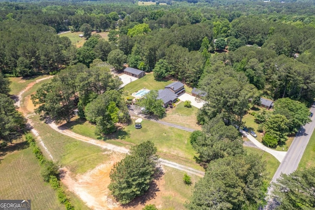 aerial view of property's location featuring a heavily wooded area