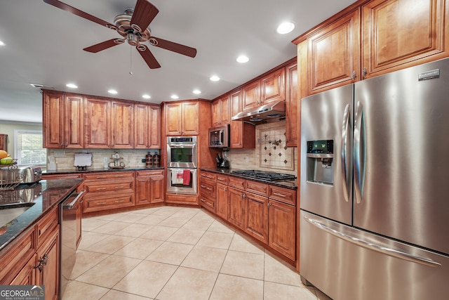 kitchen with stainless steel appliances, brown cabinetry, a ceiling fan, decorative backsplash, and recessed lighting