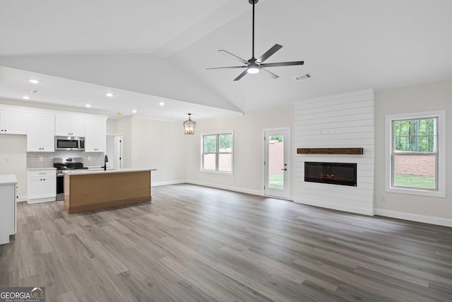 130 Rudders Xing, Newnan, GA 30263 - unfurnished living room featuring a ceiling fan, light wood finished floors, a sink, and visible vents