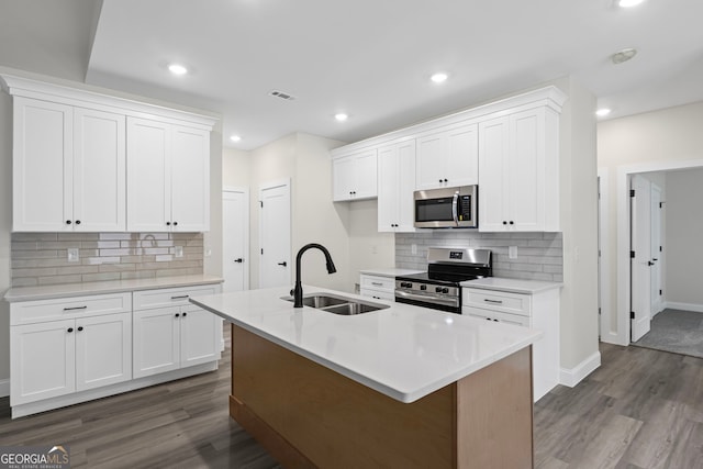 130 Rudders Xing, Newnan, GA 30263 - kitchen with stainless steel appliances, a sink, backsplash, and dark wood finished floors