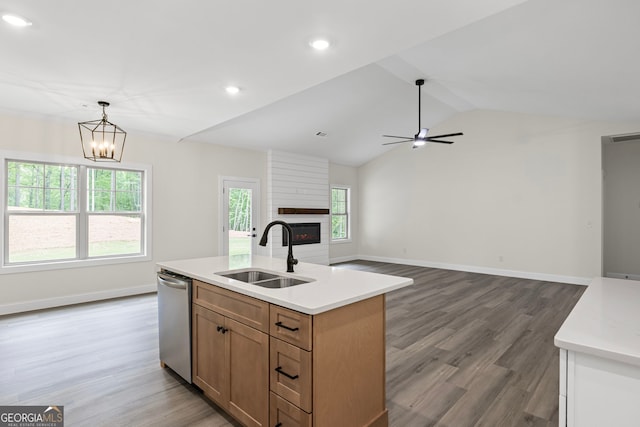 130 Rudders Xing, Newnan, GA 30263 - kitchen featuring light countertops, a fireplace, stainless steel dishwasher, and a sink
