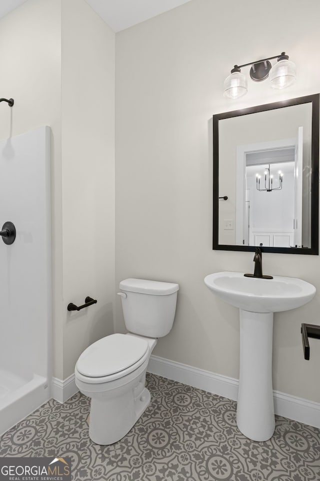 130 Rudders Xing, Newnan, GA 30263 - bathroom featuring baseboards, toilet, tile patterned flooring, and a shower