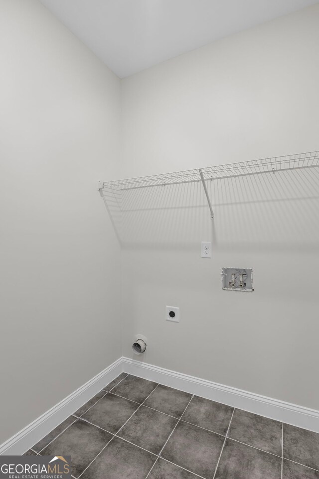 130 Rudders Xing, Newnan, GA 30263 - washroom featuring laundry area, baseboards, dark tile patterned flooring, electric dryer hookup, and washer hookup