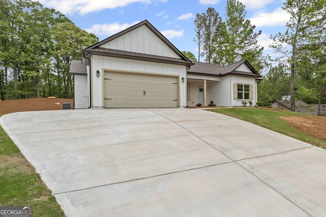 130 Rudders Xing, Newnan, GA 30263 - view of front of property featuring board and batten siding, an attached garage, a front lawn, and driveway