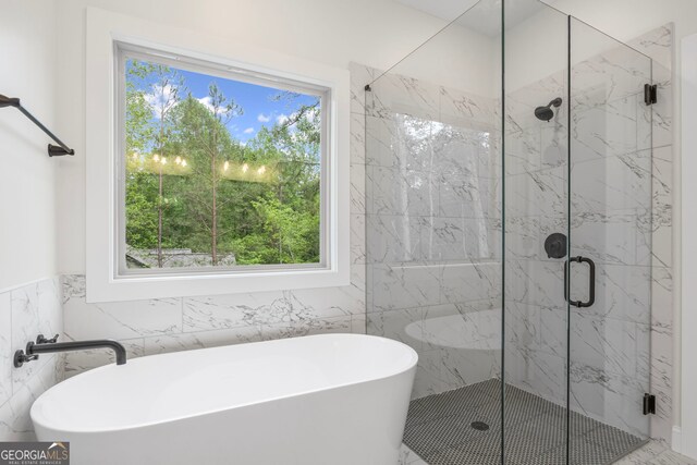 130 Rudders Xing, Newnan, GA 30263 - bathroom with tile walls, a marble finish shower, and a freestanding bath