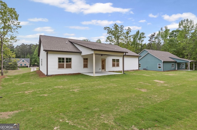 130 Rudders Xing, Newnan, GA 30263 - back of house with a ceiling fan, a patio area, roof with shingles, and a lawn