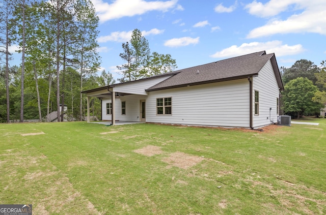 130 Rudders Xing, Newnan, GA 30263 - back of property featuring roof with shingles, a yard, central AC, and a patio