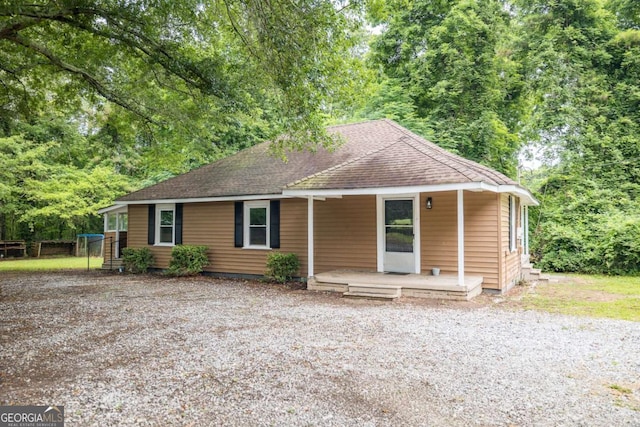 451 Woodlawn Dr, Crawford, GA 30630 - single story home featuring gravel driveway, roof with shingles, and covered porch