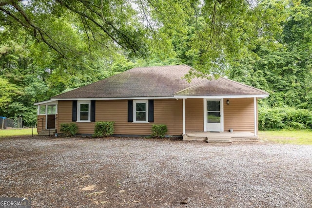 451 Woodlawn Dr, Crawford, GA 30630 - ranch-style house featuring a porch, gravel driveway, and a shingled roof