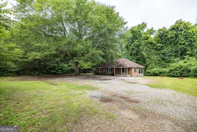 451 Woodlawn Dr, Crawford, GA 30630 - view of yard with a porch, driveway, and a forest view