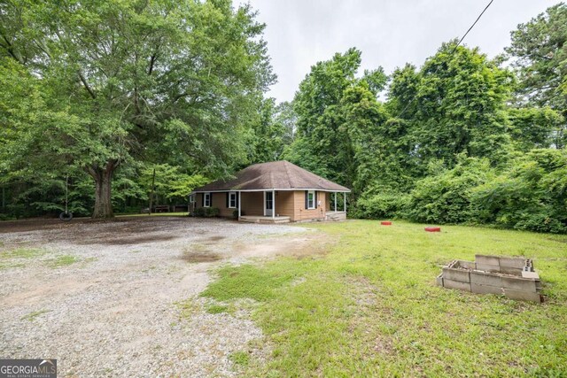 451 Woodlawn Dr, Crawford, GA 30630 - view of front of property with gravel driveway, covered porch, and a front yard