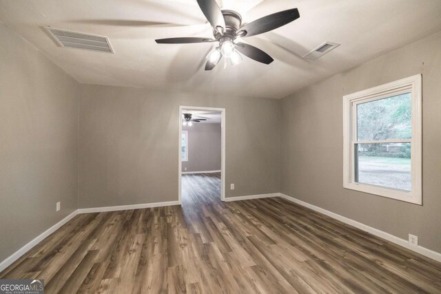 451 Woodlawn Dr, Crawford, GA 30630 - unfurnished room featuring dark wood-style flooring, a ceiling fan, visible vents, and baseboards
