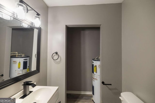 451 Woodlawn Dr, Crawford, GA 30630 - half bathroom featuring electric water heater, wood finished floors, vanity, and toilet