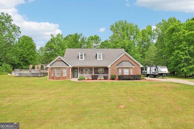 122 Eagle View Dr, Monticello, GA 31064 - cape cod house featuring brick siding, a porch, and a front yard