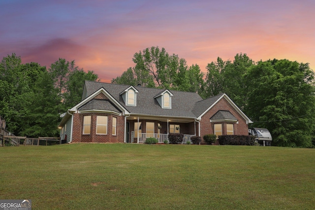 122 Eagle View Dr, Monticello, GA 31064 - cape cod-style house featuring a porch, brick siding, and a front lawn