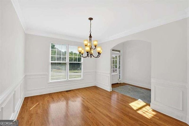 kitchen with light wood-type flooring, a sink, appliances with stainless steel finishes, and crown molding