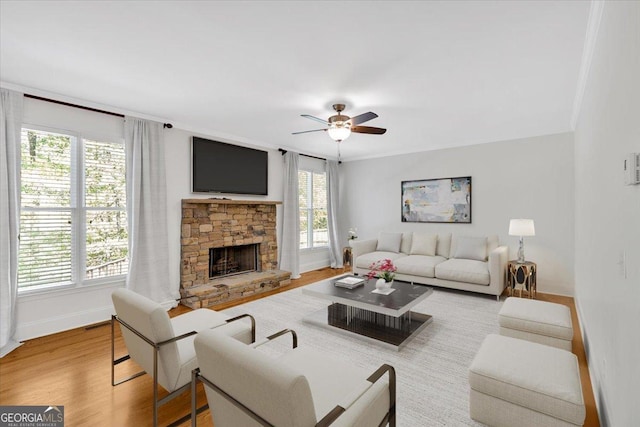 unfurnished living room featuring a wealth of natural light, baseboards, and ceiling fan