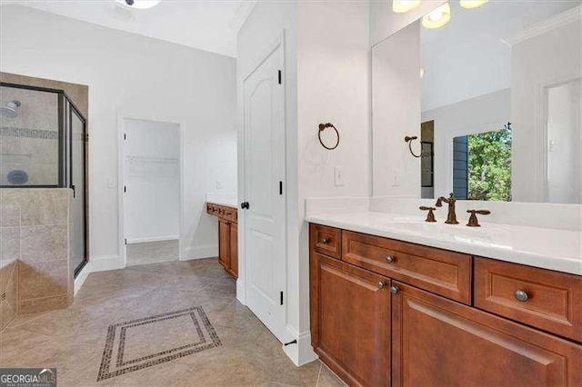 full bath featuring a shower with shower door, vaulted ceiling, vanity, crown molding, and baseboards