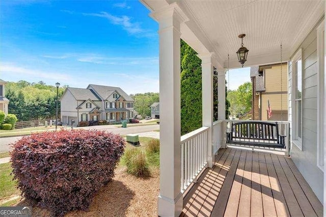 entrance foyer with a decorative wall, arched walkways, a towering ceiling, wood finished floors, and stairs