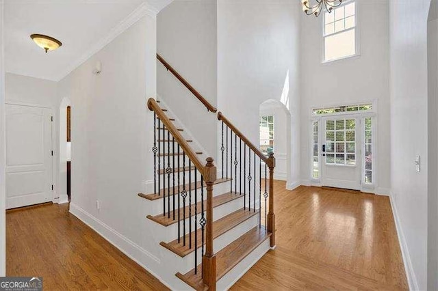 unfurnished dining area featuring arched walkways, an inviting chandelier, visible vents, and a healthy amount of sunlight