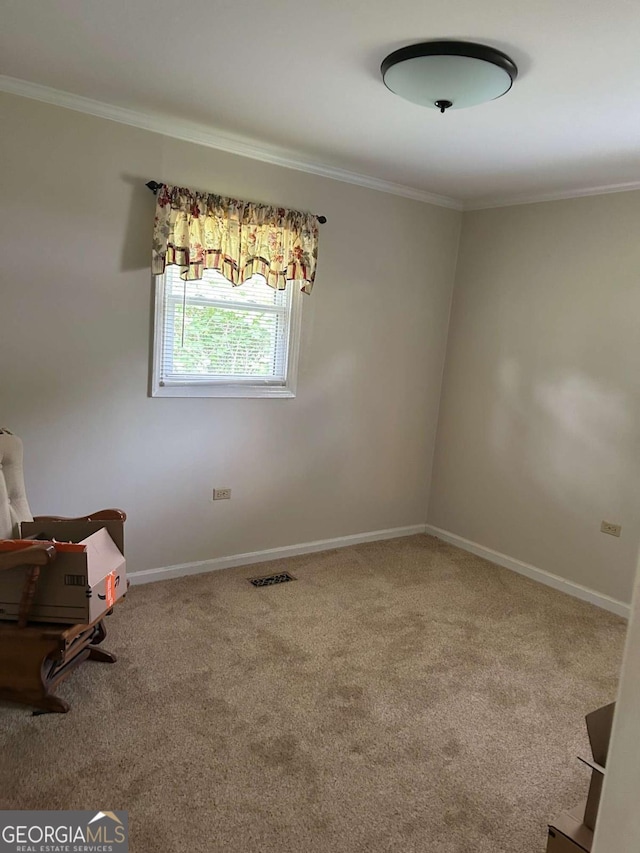 unfurnished room featuring visible vents, baseboards, carpet flooring, and crown molding