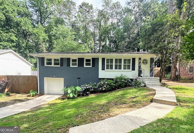 1907 Shalimar Dr NE, Atlanta, GA 30345 - view of front of house with driveway, an attached garage, and brick siding
