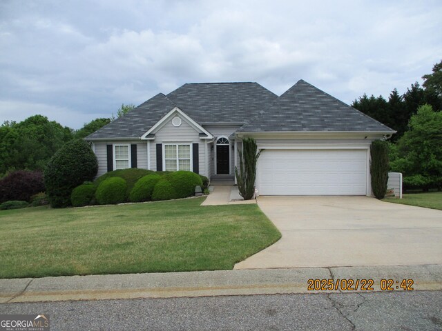 single story home with concrete driveway, a front lawn, and a garage