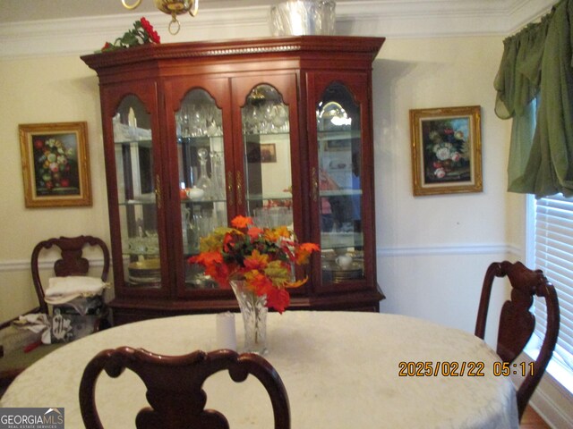 dining space featuring crown molding