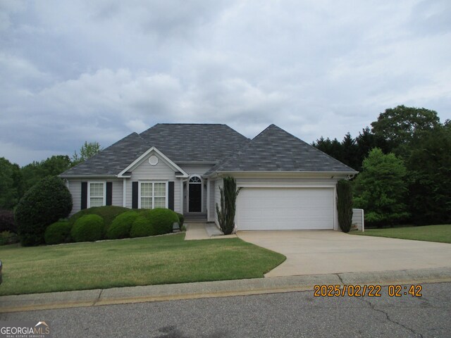 single story home featuring a front lawn, driveway, roof with shingles, and a garage