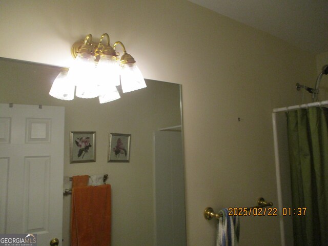 interior space featuring a chandelier and a shower with curtain
