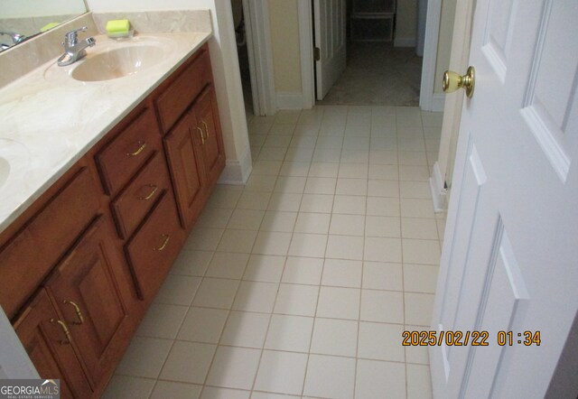 bathroom featuring double vanity, tile patterned flooring, and a sink