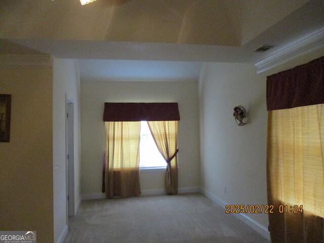 carpeted spare room with visible vents and baseboards