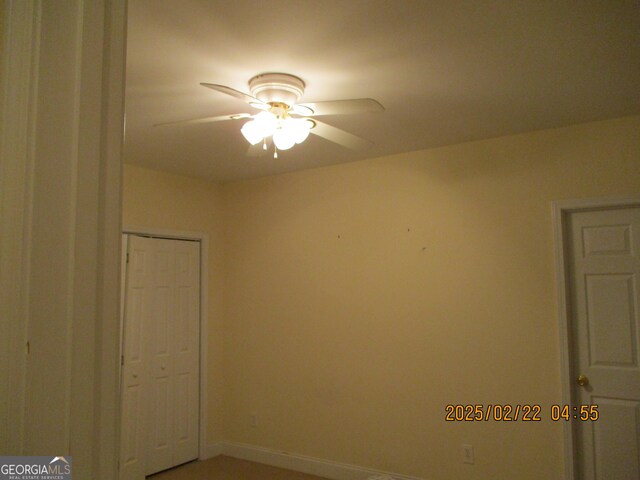 spare room featuring baseboards and a ceiling fan