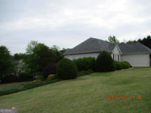 view of side of property featuring a yard