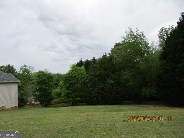 view of home's exterior featuring a lawn, fence, and a chimney