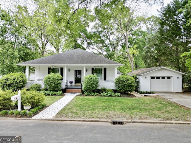 view of front of house with a porch, an outdoor structure, a front lawn, and concrete driveway