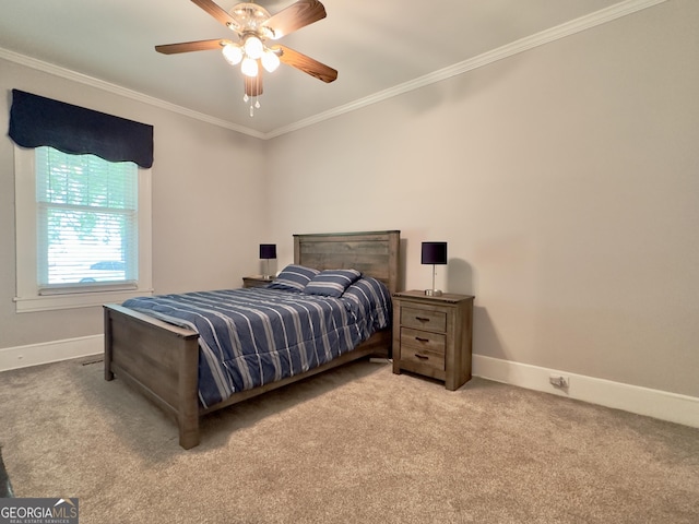 carpeted bedroom with baseboards, ornamental molding, and ceiling fan