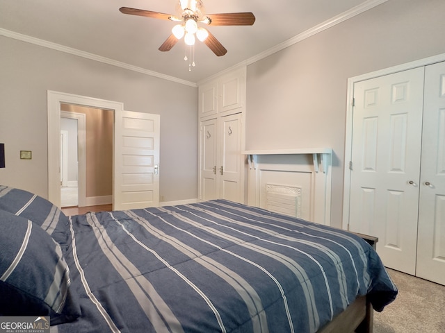 carpeted bedroom with ceiling fan, ornamental molding, and a closet