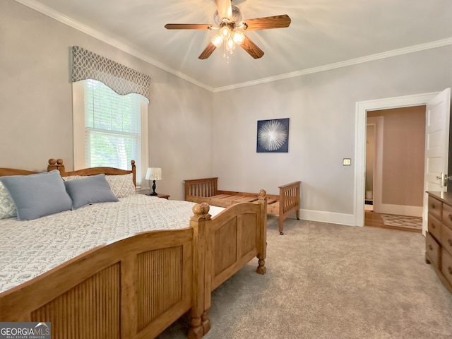 bedroom featuring baseboards, ornamental molding, light carpet, and a ceiling fan