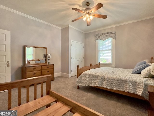 carpeted bedroom featuring crown molding, a ceiling fan, and baseboards