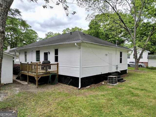 back of house featuring roof with shingles, central air condition unit, a lawn, and a deck