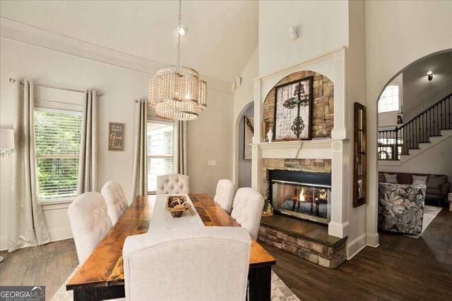 175 Tillman Ln, Athens, GA 30606 - dining space with wood finished floors, arched walkways, high vaulted ceiling, a chandelier, and a stone fireplace