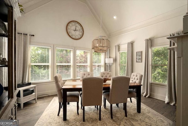 175 Tillman Ln, Athens, GA 30606 - dining area with ornamental molding, high vaulted ceiling, wood finished floors, a chandelier, and plenty of natural light