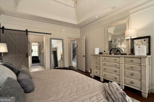 175 Tillman Ln, Athens, GA 30606 - bedroom featuring a barn door, ornamental molding, and dark wood-type flooring