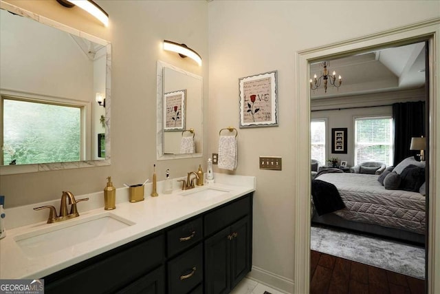 175 Tillman Ln, Athens, GA 30606 - ensuite bathroom with double vanity, a chandelier, and baseboards