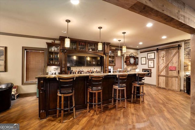 175 Tillman Ln, Athens, GA 30606 - indoor wet bar with a barn door, baseboards, wood finished floors, crown molding, and hanging light fixtures