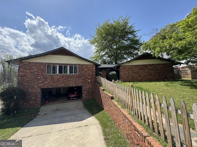 2461 Mcalpin Ter, East Point, GA 30344 - view of side of home featuring driveway, an attached garage, and brick siding