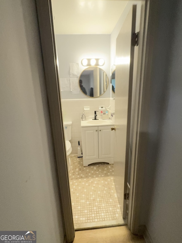 2461 Mcalpin Ter, East Point, GA 30344 - half bath with vanity, tile patterned floors, wainscoting, and tile walls